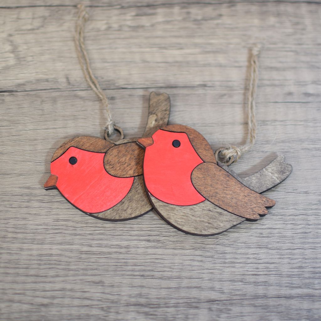 Two wooden, hand painted laser cut robin hanging decorations with jute twine hangers