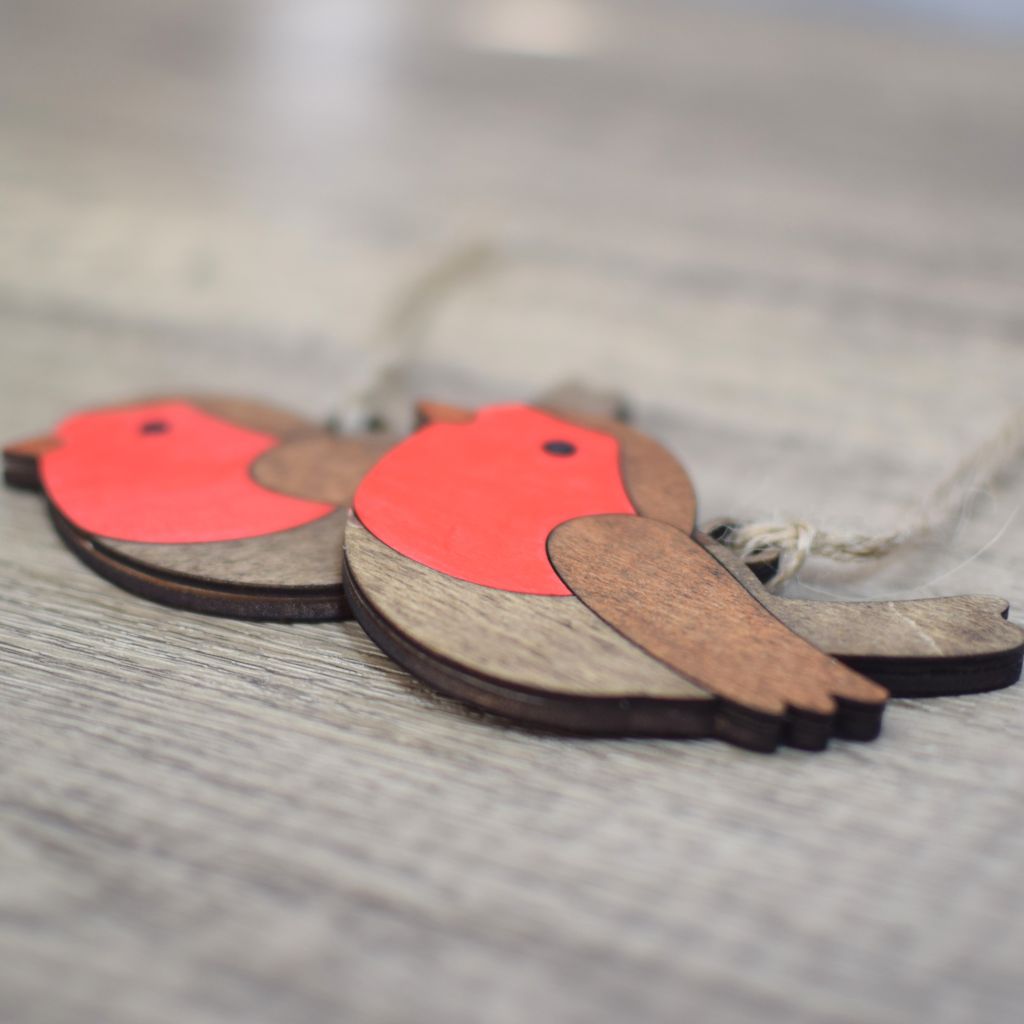 Two wooden hanging decorations with jute twine