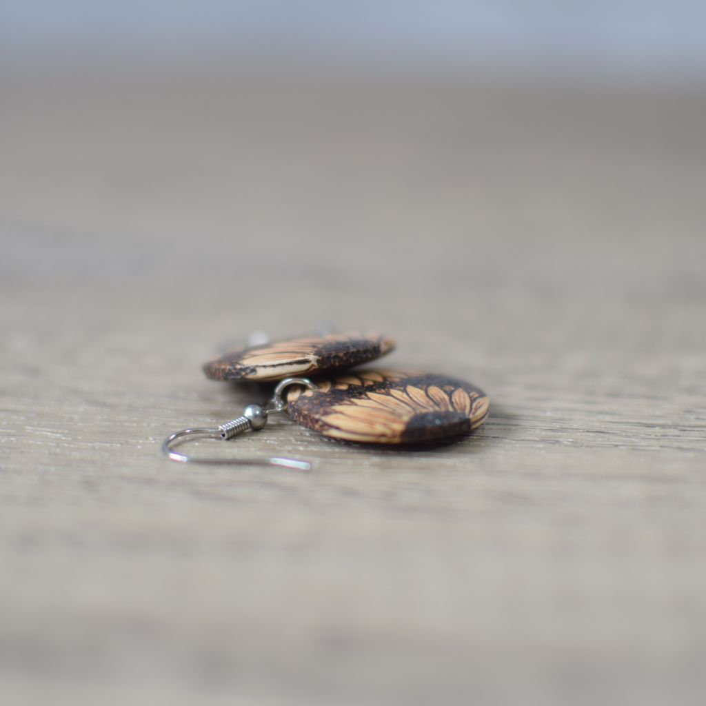 pyrography earrings photo showing the side view with the design wrapping around the edge
