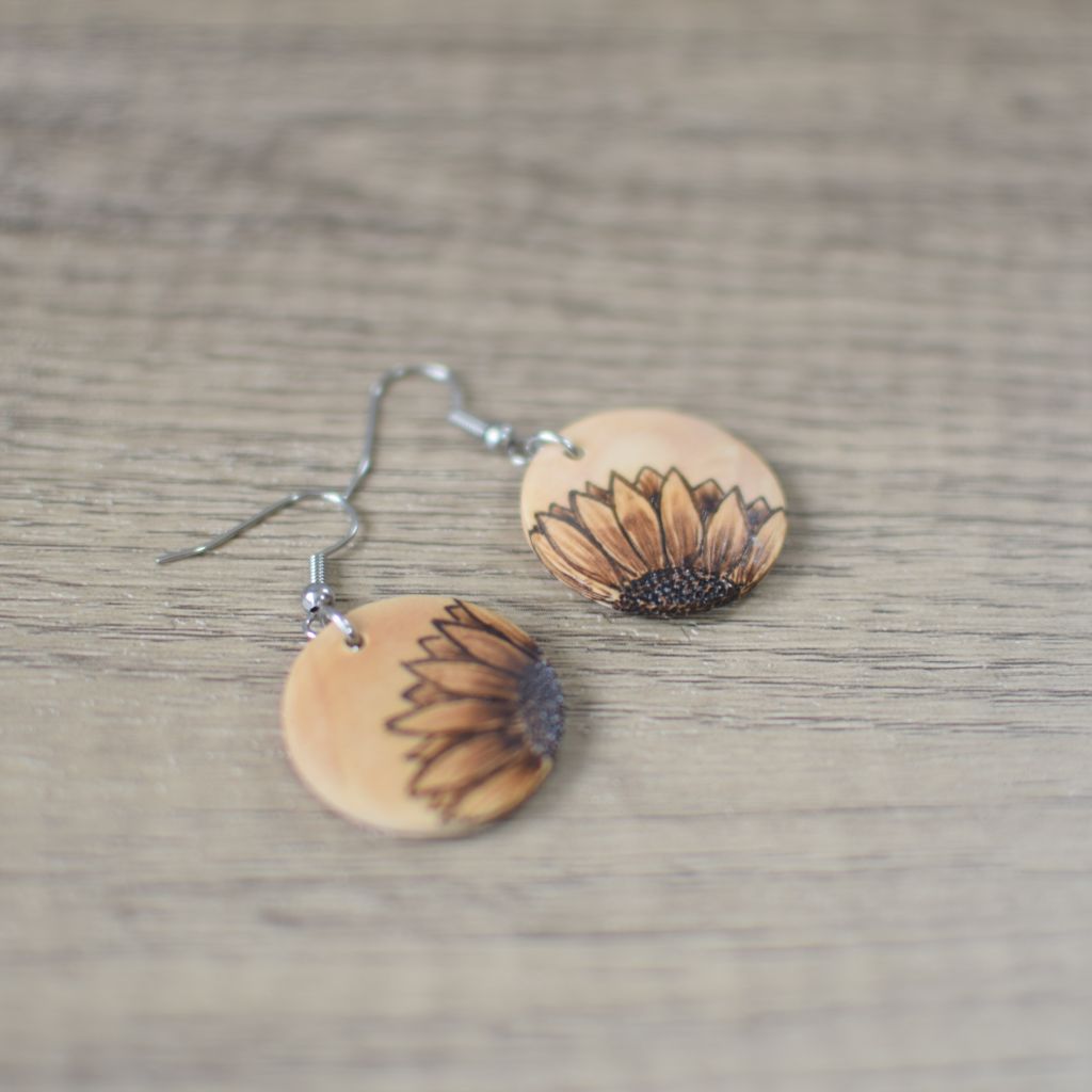 photo showing sunflower design pyrography earrings