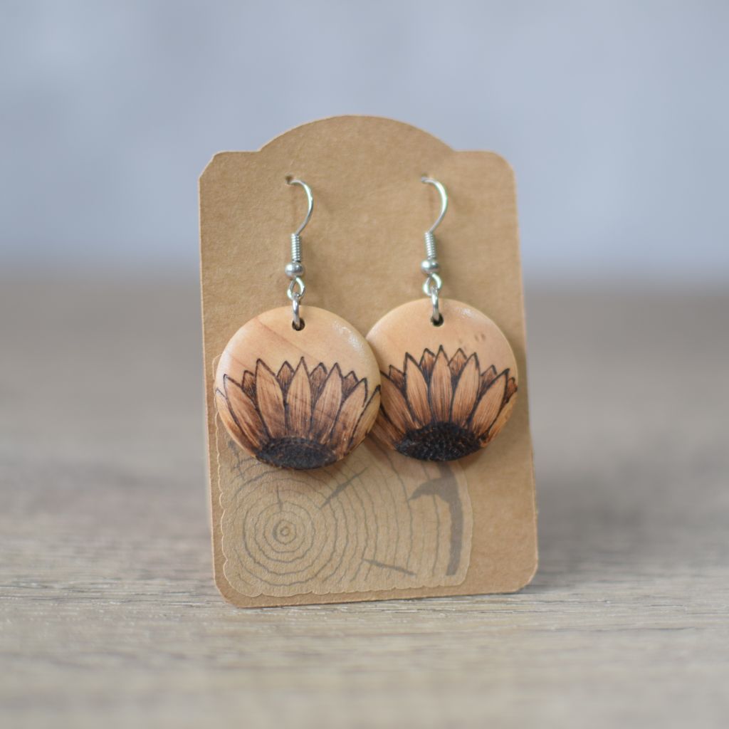 Photo of pyrography drop earrings with half sunflower design