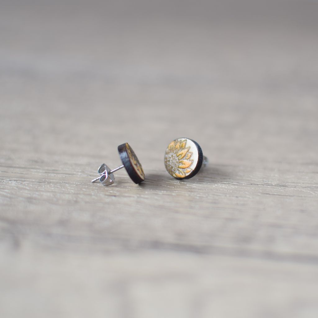 photo showing wooden earrings. sunflower design