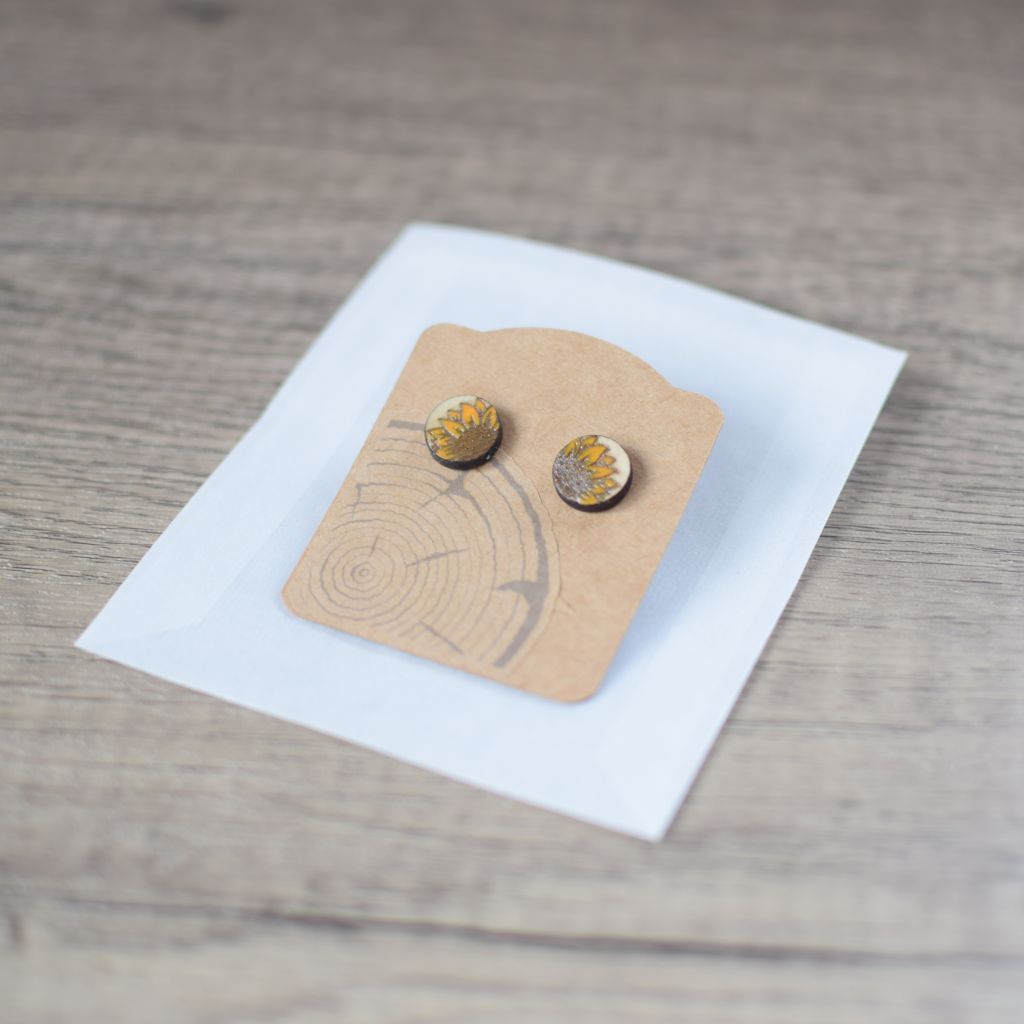 photo showing the earring on the kraft card backing and a glassine gift bag