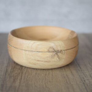 photo showing the oak decorative side view. The twine is inset into the bowl and tied with a simple bow.