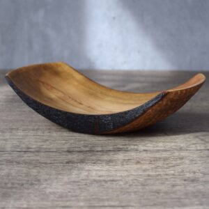 Ash wood turned dish. A shallow long dish turned from an Ash log. The bottom of the dish has bee textured with a rotary tool