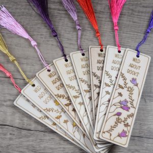 A selection of wooden laser engraved, hand painted book marks with colourful tassel