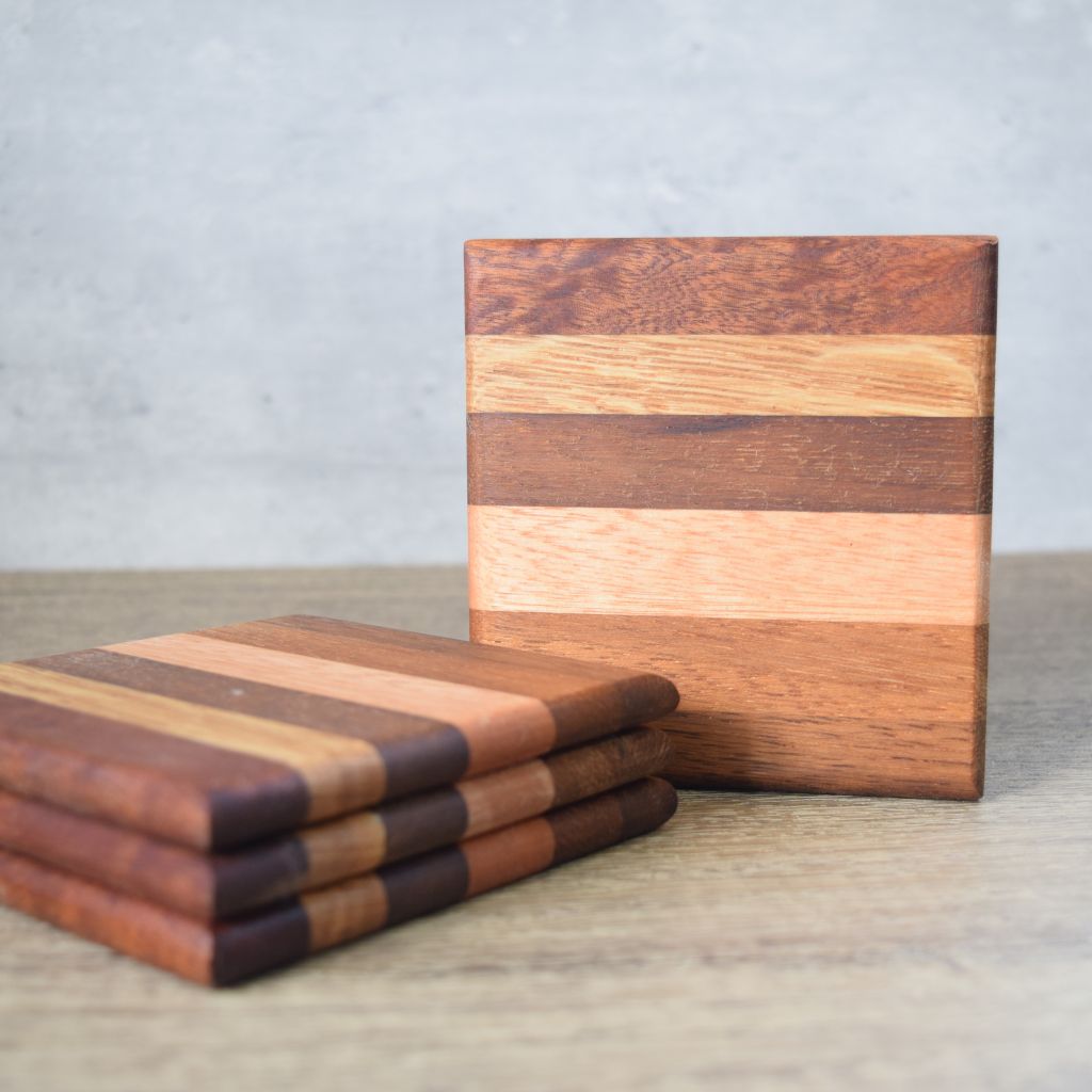 set of four hardwood crasters each coaster is made from sections of hardwoods.